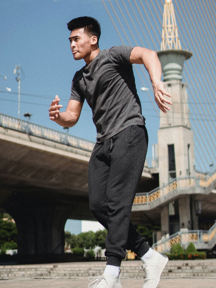 Man Dancing by a Bridge